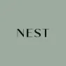 The word NEST is centered in black uppercase letters on a muted green-gray background.